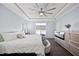 Light-filled main bedroom with hardwood floors, fireplace, tray ceiling, and large window, creating a cozy ambiance at 5520 Advancing Ave, Raleigh, NC 27616