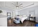 Well-lit main bedroom with hardwood floors, a ceiling fan, and ample space, perfect for relaxation and rest at 5520 Advancing Ave, Raleigh, NC 27616
