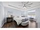 Spacious main bedroom with tray ceilings, a ceiling fan, and hardwood floors, offering a serene retreat at 5520 Advancing Ave, Raleigh, NC 27616