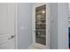 Walk-in pantry with etched glass door offering ample storage for Gathering food, adjacent to a coat closet at 5520 Advancing Ave, Raleigh, NC 27616