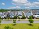 Charming, colorful single-Gathering homes line a street with young trees and well-manicured lawns at 5520 Advancing Ave, Raleigh, NC 27616