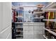 Well-organized walk-in closet with custom shelving, drawers, and hanging rods, providing ample storage space at 5520 Advancing Ave, Raleigh, NC 27616