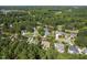 Stunning aerial view of 5708 Creekfall Ln showcasing lush greenery and beautiful homes in the neighborhood at 5708 Creekfall Ln, Fuquay Varina, NC 27526