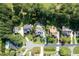 Aerial view of residences in a wooded community showcasing lush landscapes and mature trees at 5708 Creekfall Ln, Fuquay Varina, NC 27526