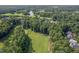 Scenic aerial view showcasing the community's proximity to a golf course, lake and lush green spaces at 5708 Creekfall Ln, Fuquay Varina, NC 27526