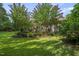 Backyard view of the patio, pool, pergola, and mature trees at 5708 Creekfall Ln, Fuquay Varina, NC 27526