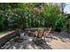 Stone patio with rocking chairs surrounding a stone fire pit at 5708 Creekfall Ln, Fuquay Varina, NC 27526
