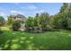 Sprawling backyard with mature trees, and lush landscaping at 5708 Creekfall Ln, Fuquay Varina, NC 27526