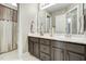 Elegant bathroom featuring a double vanity with marble countertop and modern fixtures, plus a shower/tub combination at 5708 Creekfall Ln, Fuquay Varina, NC 27526
