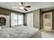 Bedroom featuring natural light from a large window and ensuite bathroom access at 5708 Creekfall Ln, Fuquay Varina, NC 27526