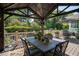 Deck with a large outdoor dining table, potted plants, and grill at 5708 Creekfall Ln, Fuquay Varina, NC 27526