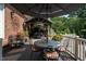 A view of the wooden deck with a dining table, potted flowers, and lounge chairs at 5708 Creekfall Ln, Fuquay Varina, NC 27526
