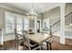 Spacious dining room featuring a large window, a decorative chandelier and a view of the entryway at 5708 Creekfall Ln, Fuquay Varina, NC 27526