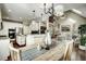 Open dining room with kitchen access, hardwood floors, and modern lighting at 5708 Creekfall Ln, Fuquay Varina, NC 27526