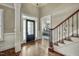 Elegant foyer featuring hardwood floors, staircase with wrought iron spindles, and leaded glass front door at 5708 Creekfall Ln, Fuquay Varina, NC 27526