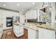 Bright kitchen featuring white cabinets, stainless steel appliances, and a wood-topped island at 5708 Creekfall Ln, Fuquay Varina, NC 27526