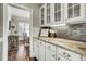 Bright kitchen featuring white cabinets, granite countertops and hardwood floors at 5708 Creekfall Ln, Fuquay Varina, NC 27526
