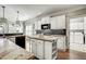 Spacious kitchen with white cabinets, an island, dark backsplash, and modern appliances at 5708 Creekfall Ln, Fuquay Varina, NC 27526