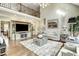 Spacious living room with hardwood floors, high ceilings, and a decorative fireplace at 5708 Creekfall Ln, Fuquay Varina, NC 27526
