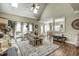 Inviting living room with a soaring ceiling, skylights, and a charming wicker coffee table at 5708 Creekfall Ln, Fuquay Varina, NC 27526