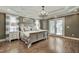Stunning main bedroom with a decorative tray ceiling, chandelier, and access to the backyard at 5708 Creekfall Ln, Fuquay Varina, NC 27526
