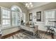 Charming home office with natural light from large windows and a decorative rug, a perfect workspace at 5708 Creekfall Ln, Fuquay Varina, NC 27526