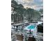 Backyard with in-ground pool and surrounding patio covered in winter snow, surrounded by mature trees at 5708 Creekfall Ln, Fuquay Varina, NC 27526