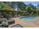 Backyard pool area with an attractive pergola, lounge chairs, and flowerbeds at 5708 Creekfall Ln, Fuquay Varina, NC 27526