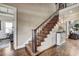 Beautiful staircase with hardwood treads, wrought iron railing, and wainscoting, a warm and inviting space at 5708 Creekfall Ln, Fuquay Varina, NC 27526