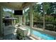 Sunroom overlooking pool, with large windows and built-in storage at 5708 Creekfall Ln, Fuquay Varina, NC 27526