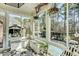 Bright sunroom featuring large windows with views of the backyard and pool at 5708 Creekfall Ln, Fuquay Varina, NC 27526