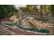 Aerial view of the community entrance with stone structures, waterfalls and lush landscaping at 59 Riverstone Dr, Pittsboro, NC 27312