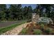 Stone monument at the community entrance with landscaped grounds and decorative rocks at 59 Riverstone Dr, Pittsboro, NC 27312