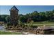 Stone entrance feature, well-manicured landscape, and a small, decorative water feature at 59 Riverstone Dr, Pittsboro, NC 27312