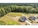 Aerial view of new home with a large grassy backyard surrounded by mature trees at 60 Pintail Lane Ln, Youngsville, NC 27596