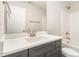 Modern bathroom featuring a gray vanity with white countertop and shower-tub combination at 60 Pintail Lane Ln, Youngsville, NC 27596