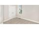 Bedroom with neutral carpet, light gray walls, a double door closet and a window with a view of the outdoors at 60 Pintail Lane Ln, Youngsville, NC 27596