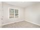 Bright bedroom with neutral carpet, light gray walls, and a window with a view of the outdoors at 60 Pintail Lane Ln, Youngsville, NC 27596