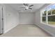 Bedroom featuring neutral carpeting, a ceiling fan, and a large window overlooking the backyard at 60 Pintail Lane Ln, Youngsville, NC 27596