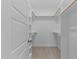 Spacious walk-in closet with carpeted floor, shelves, and racks for organization at 60 Pintail Lane Ln, Youngsville, NC 27596