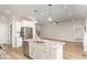 Open floor plan kitchen with granite counters, stainless appliances, and kitchen island overlooking living area at 60 Pintail Lane Ln, Youngsville, NC 27596