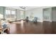 Spacious living room with hardwood floors, large windows, and stylish decor at 601 Finsbury St # 304, Durham, NC 27703