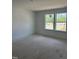 A clean, light-filled bedroom space with a view of the outdoors through large windows at 62 Shay St, Angier, NC 27501