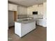 A kitchen showcasing an island with granite countertop, stainless steel appliances, and all-white cabinets at 62 Shay St, Angier, NC 27501