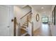 Welcoming entryway with wooden staircase, white risers, wood flooring, and a glimpse into the living area at 64 Shay St, Angier, NC 27501