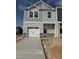Charming two-story townhome with a one-car garage and inviting gray siding at 64 Shay St, Angier, NC 27501