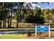 Neill's Creek Park sign with a view of greenery, trees, and a pond at 64 Shay St, Angier, NC 27501