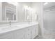 Bathroom showcasing double sinks with white cabinets, quartz countertops and framed mirrors at 6600 Ascot Ct, Raleigh, NC 27615