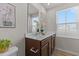 Bright bathroom with a double sink vanity and a large mirror reflecting natural light at 669 Impala Trce, Wendell, NC 27591