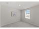 Bright bedroom featuring neutral walls, carpet floors, and a window for natural light at 669 Impala Trce, Wendell, NC 27591